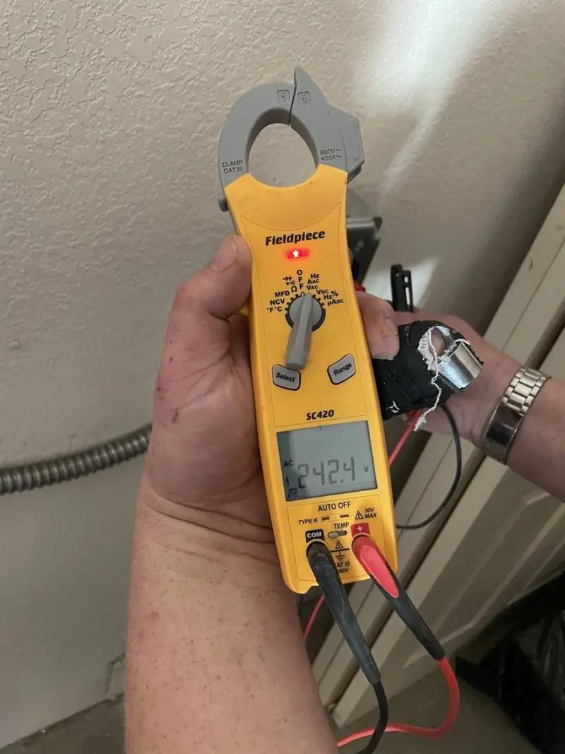 Voltage testing with clamp meter during Outlet Installation in Montgomery